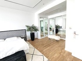 Bright contemporary bedroom with adjoining living space